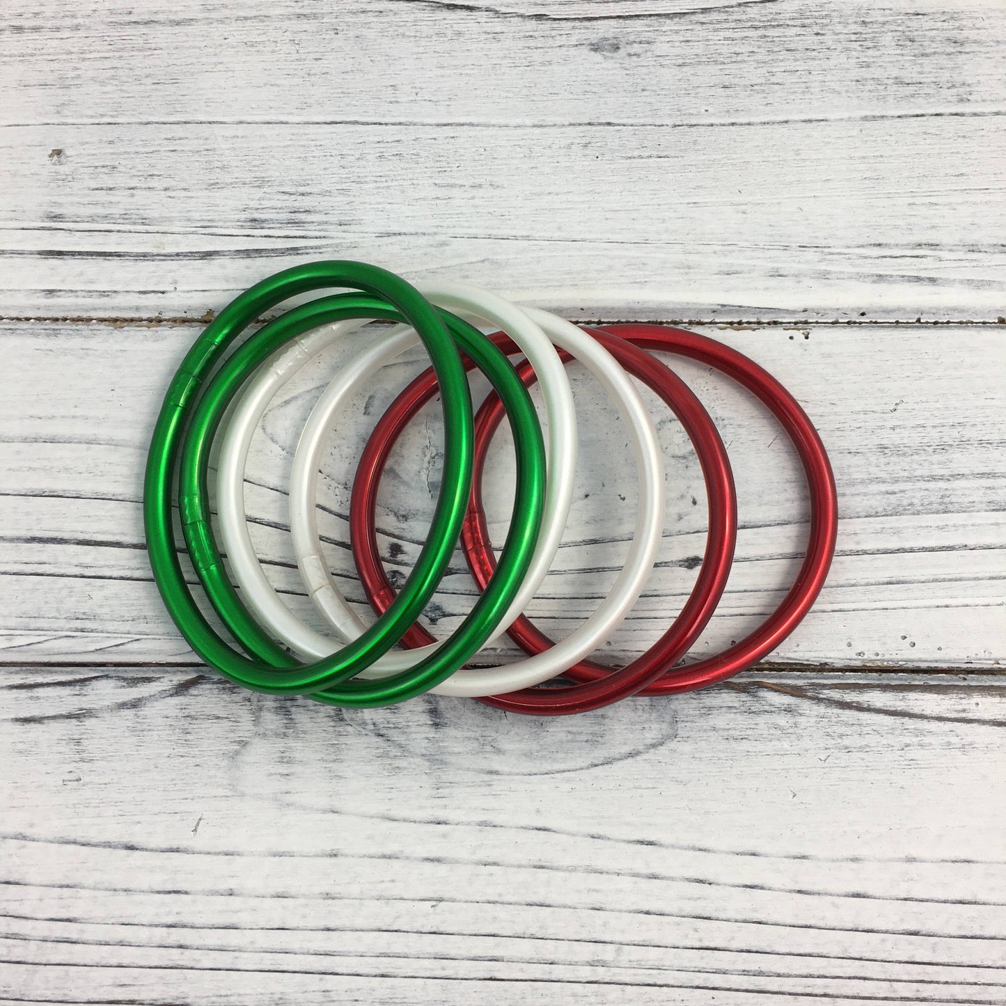 Red, green, and white bangle set 