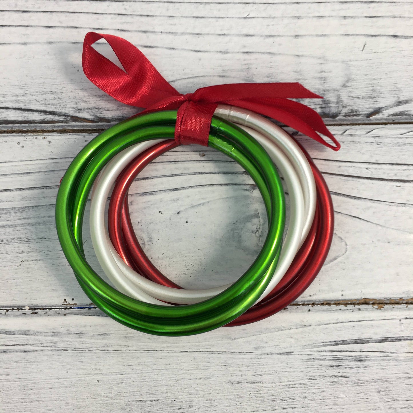 Red, green, and white bangle set 
